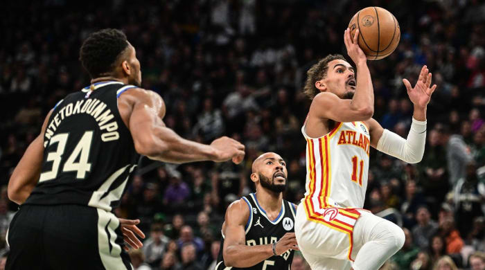 Oct 29, 2022; Milwaukee, Wisconsin, USA; Atlanta Hawks guard Trae Young (11) takes a shot against Milwaukee Bucks forward Giannis Antetokounmpo (34) and guard Jevon Carter (5) in the fourth quarter at Fiserv Forum.
